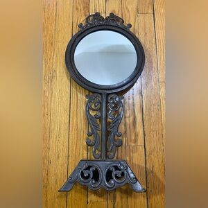 Vintage, ornate mirror with wooden backing